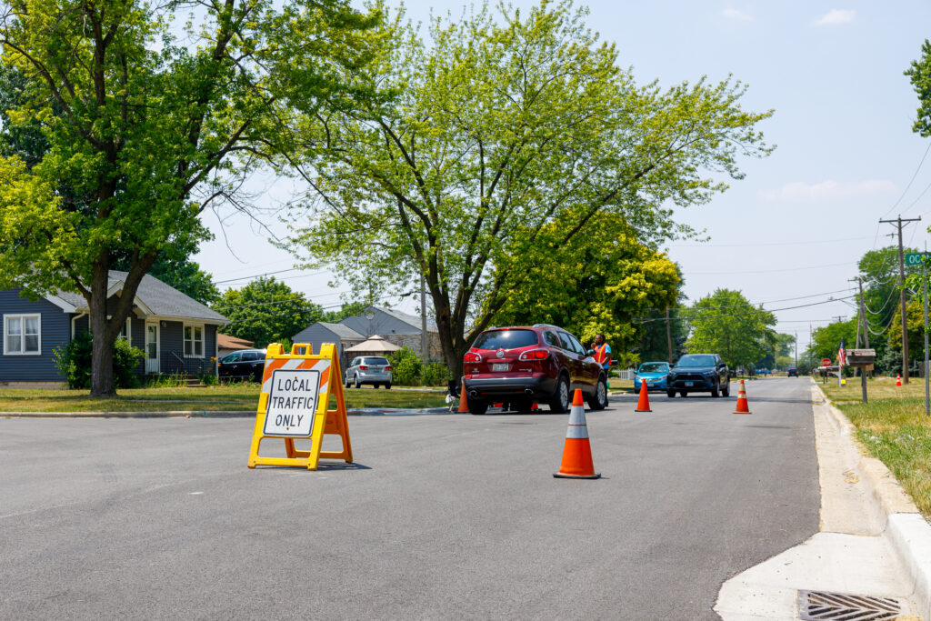 Traffic cones and a sign that says "local traffic only" are on the street.