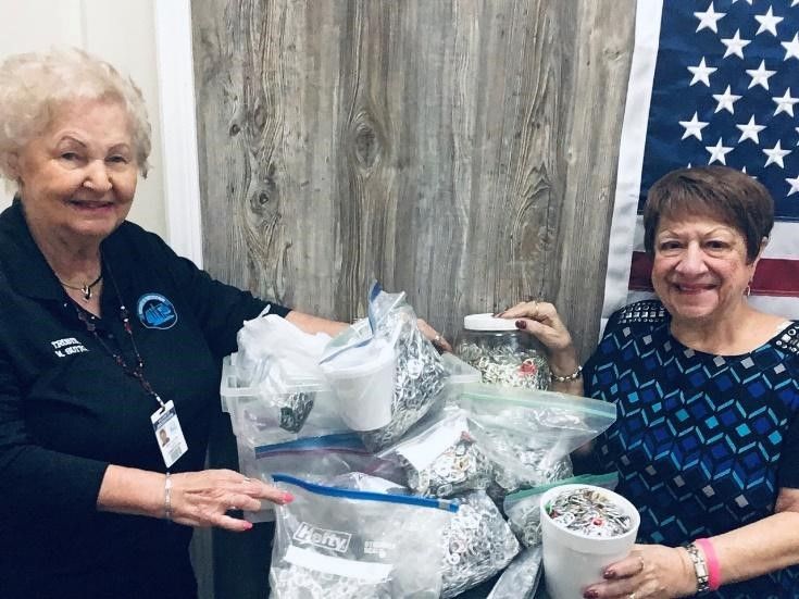 Trustee Sutton (left) and Trustee Higginson (right) hold bags of pop tabs.