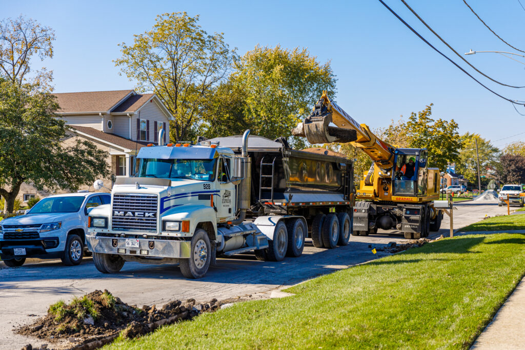 Excavator tears out portions of a residential curb in Bridgeview