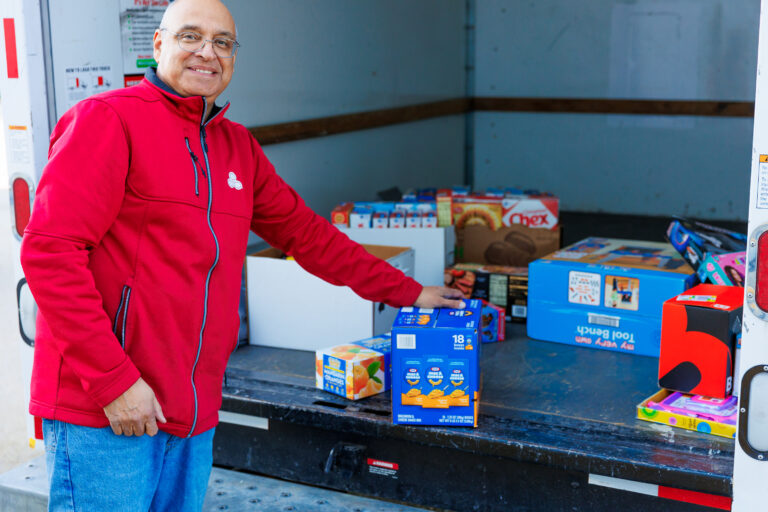 Chamber of Commerce Vice President Vic Portillo takes donated items out of a moving van.