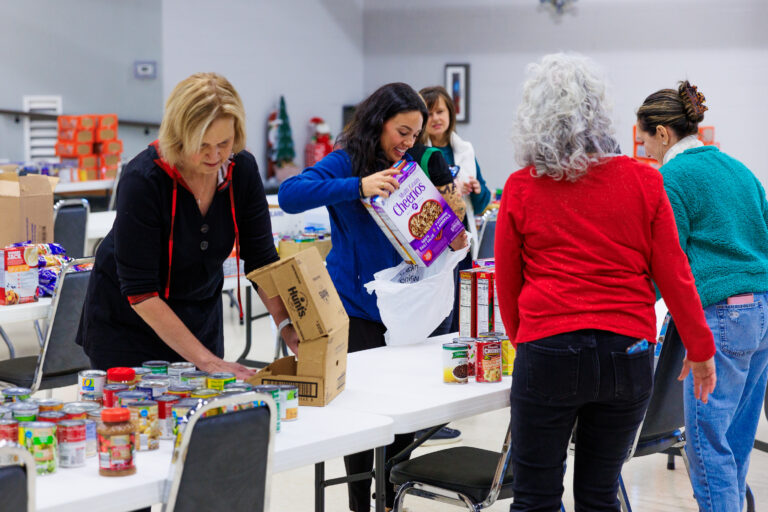 Volunteers pack nonperishable foods for distribution.