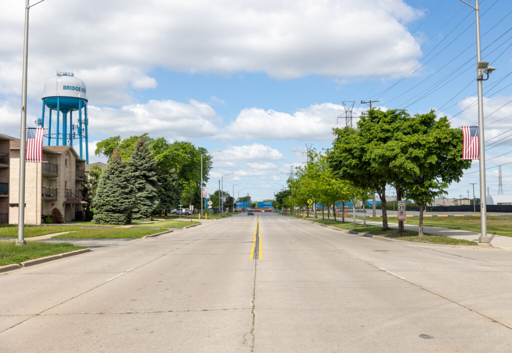 American flags are displayed on the posts along the street.