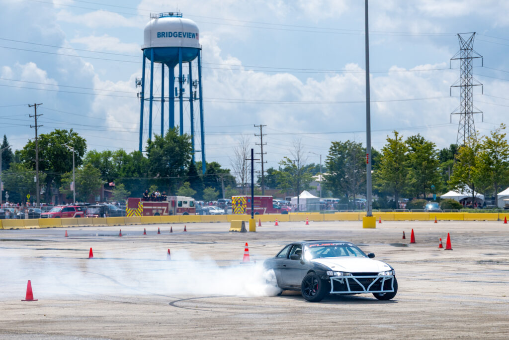 Cars furiously drift in front of SeatGeek Stadium.