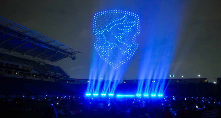 Ravenclaw House emblem is projected into the night sky.